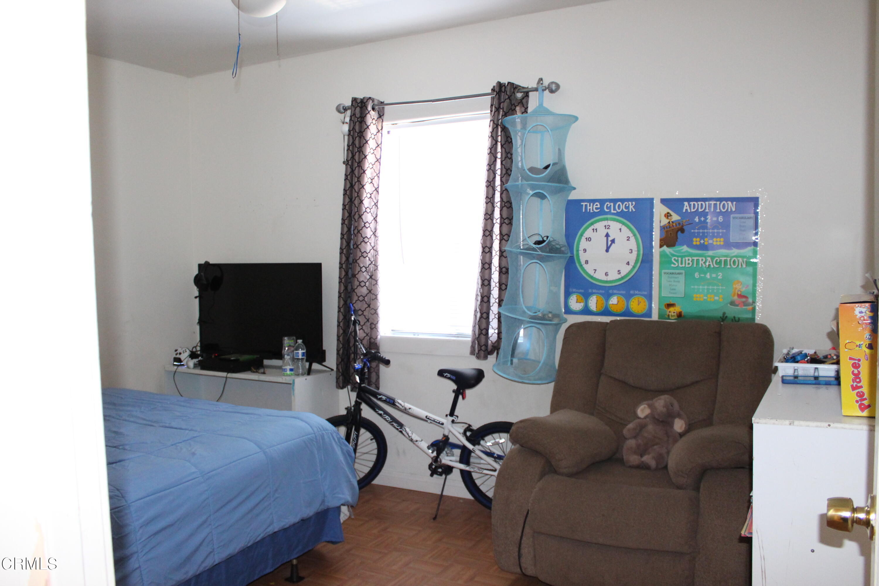 1111 South M Street Oxnard, CA 93033 - Photo 10 of 22 a living room with furniture a flat screen tv and a window