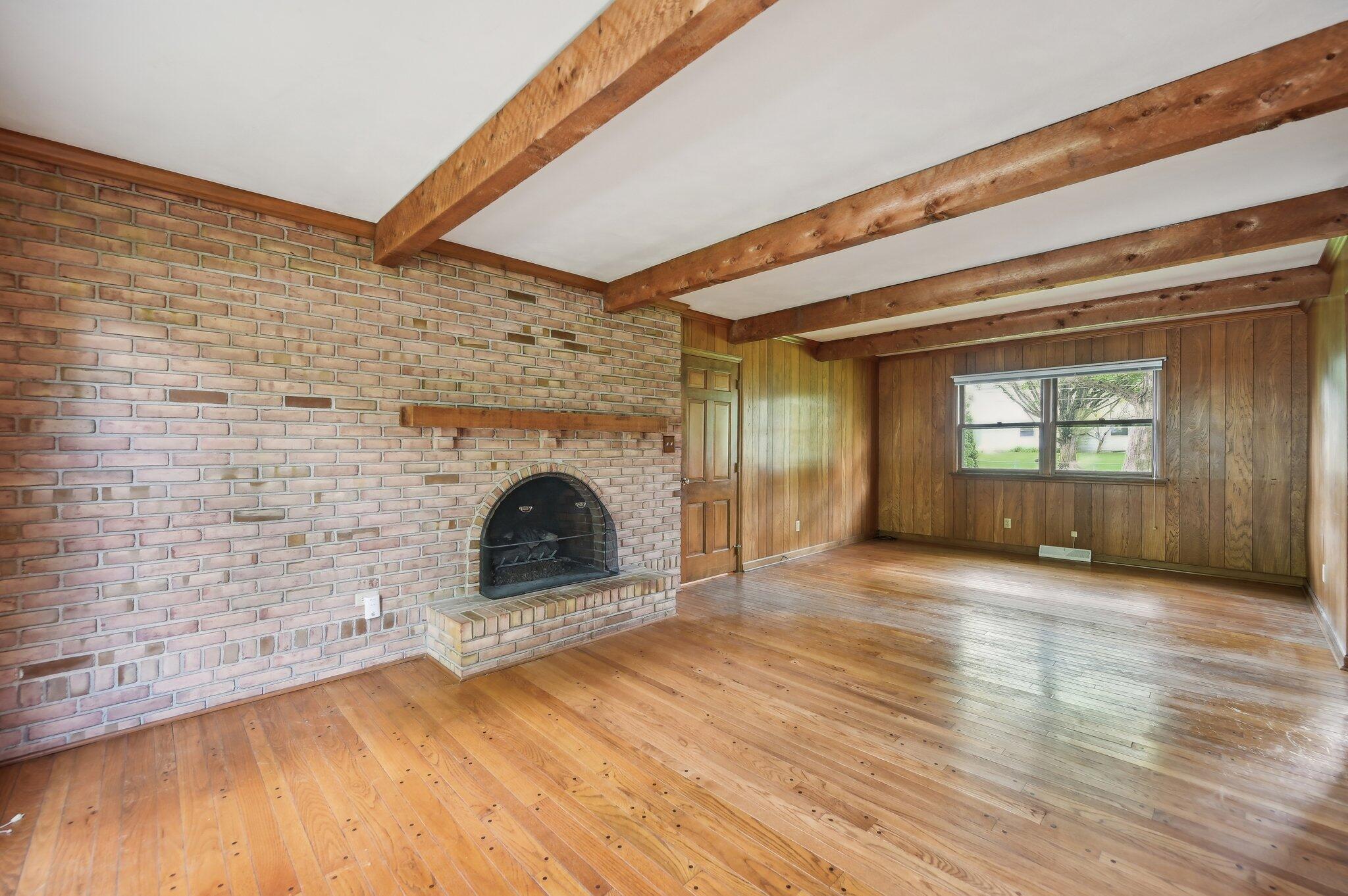 5917 Rocky Rill Road Columbus, OH 43235 - Photo 7 of 47 Family Room with Fireplace
Spacious family room features hardwood floors, a statement brick fireplace with wood mantel, and rustic ceiling beams.