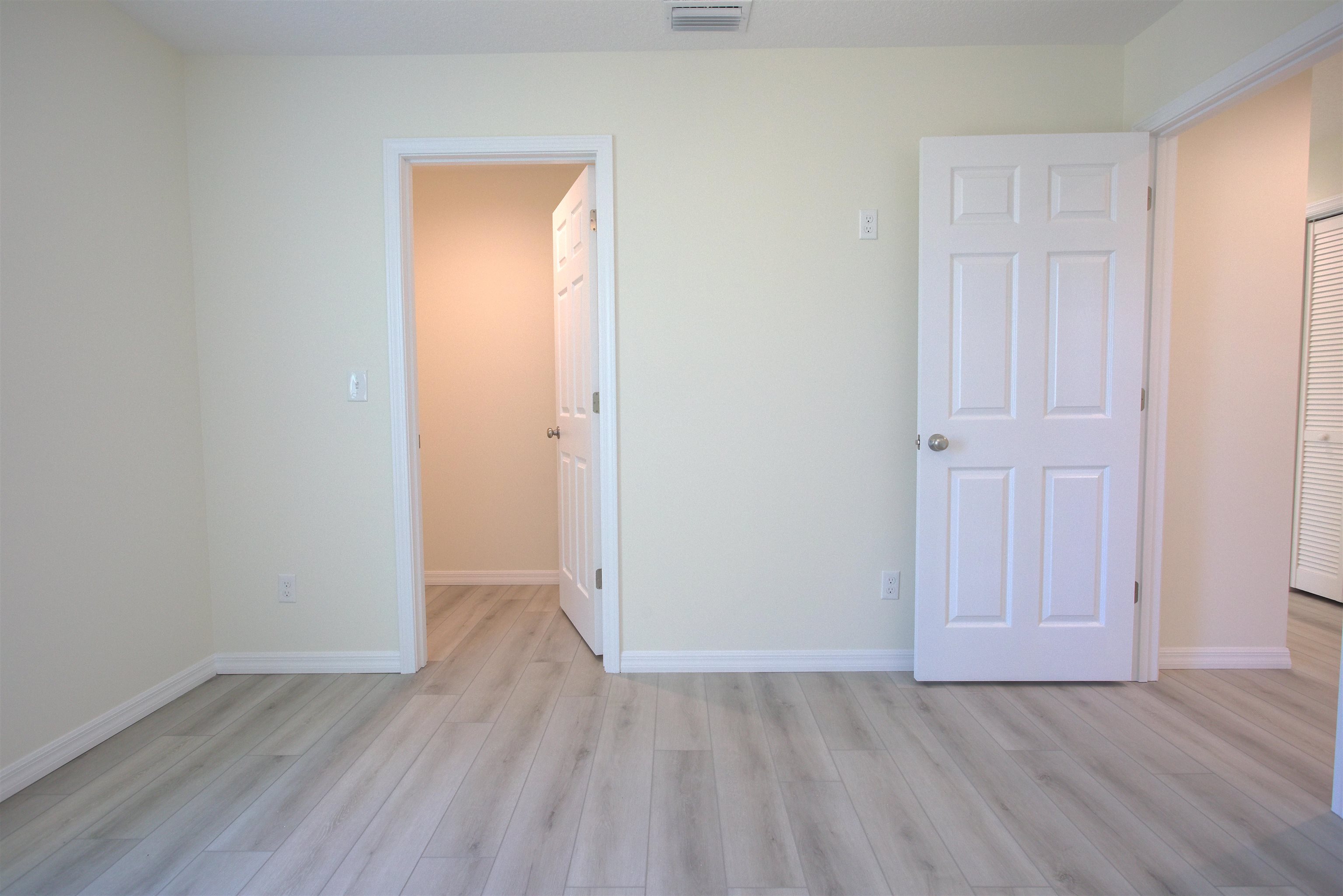 253 Desoto Road St. Augustine, FL 32080 - Photo 12 of 25 Unfurnished bedroom featuring light wood finished floors and a spacious closet