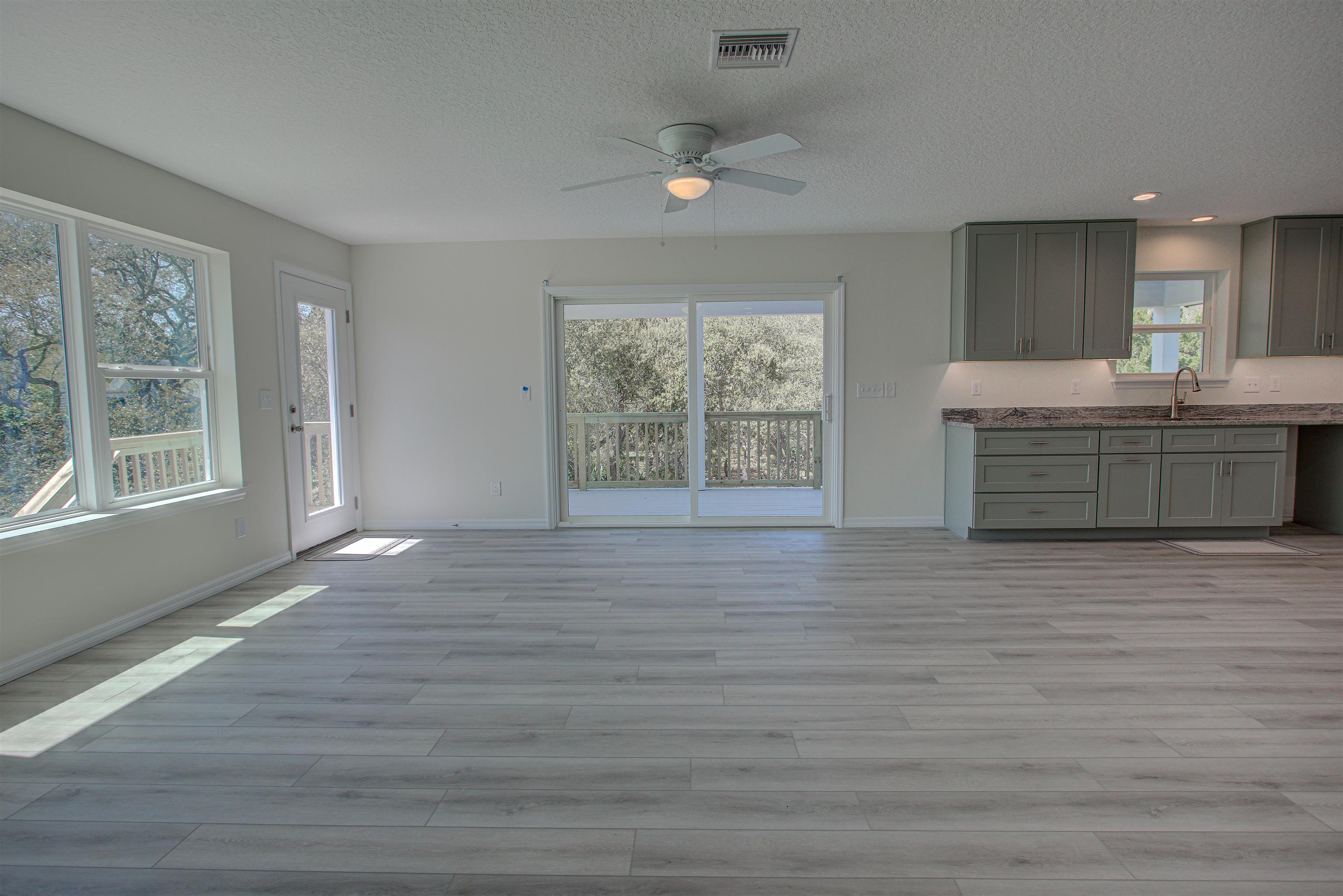 253 Desoto Road St. Augustine, FL 32080 - Photo 8 of 25 Unfurnished dining area with light wood-style flooring, a ceiling fan, and a textured ceiling