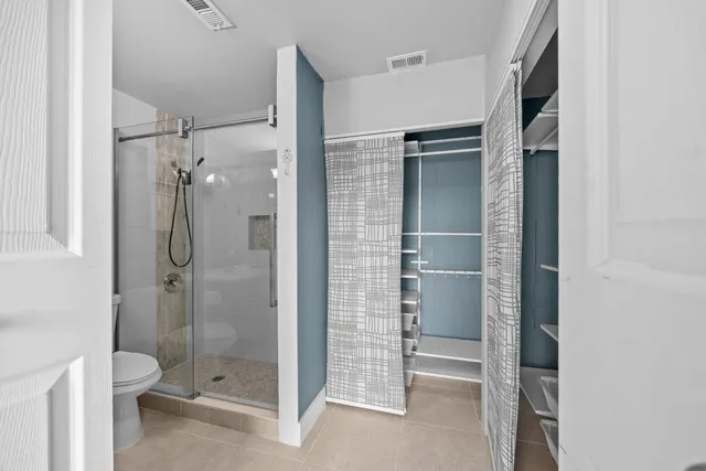 a bathroom with a shower and a toilet