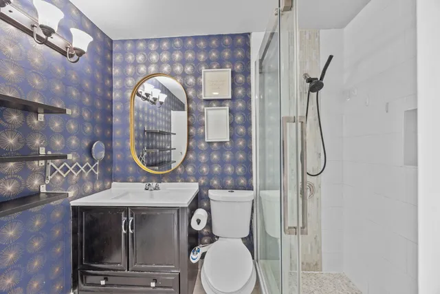 a bathroom with a toilet a sink and mirror