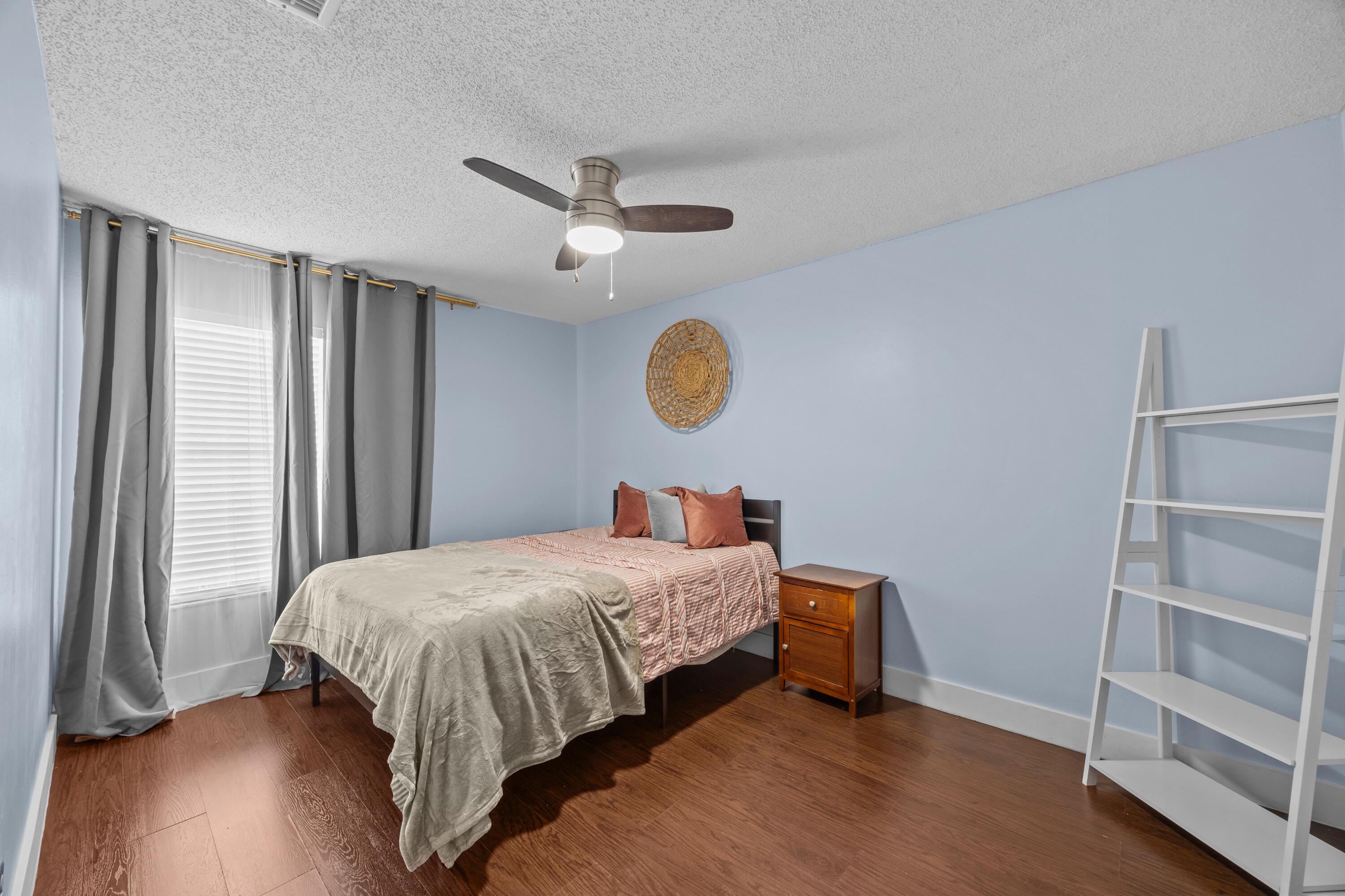 1520 Shaker Circle Wellington, FL 33414 - Photo 18 of 19 a bedroom with a bed and a window
