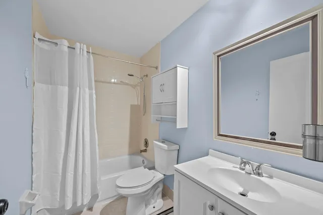 a bathroom with a sink toilet a mirror and shower