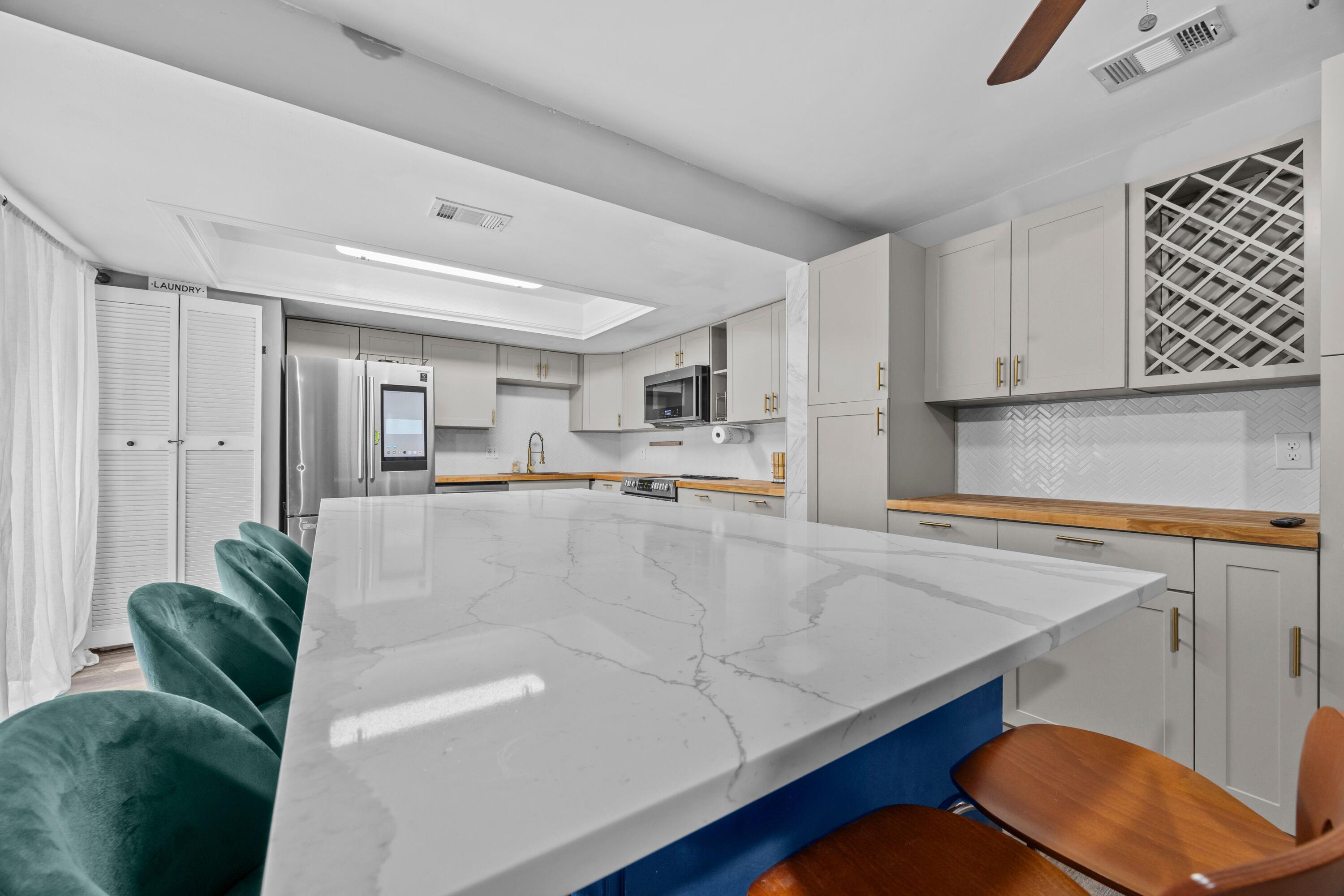 1520 Shaker Circle Wellington, FL 33414 - Photo 8 of 19 a living room with furniture and a kitchen island