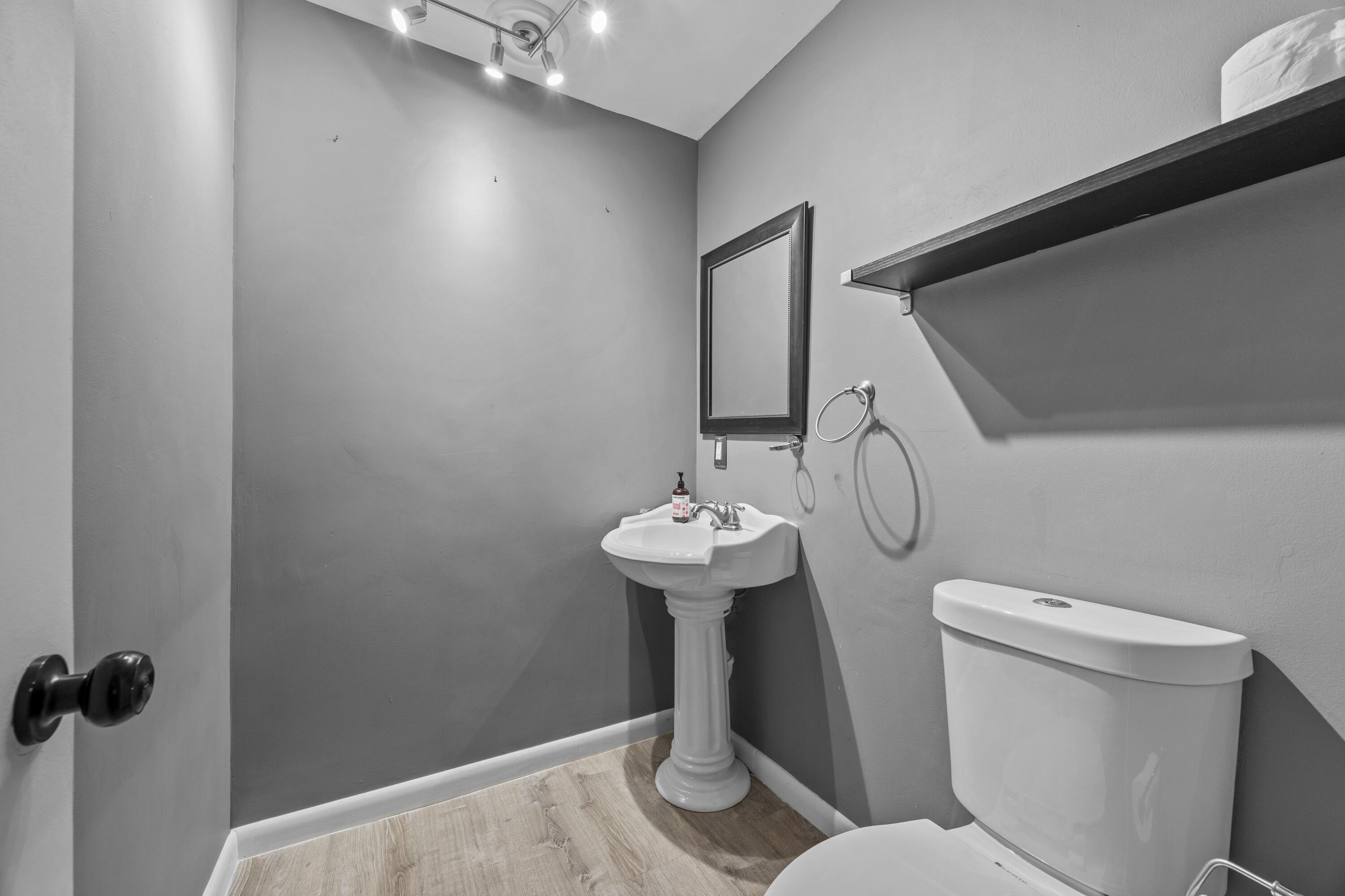 1520 Shaker Circle Wellington, FL 33414 - Photo 9 of 19 a bathroom with a sink a toilet and a mirror