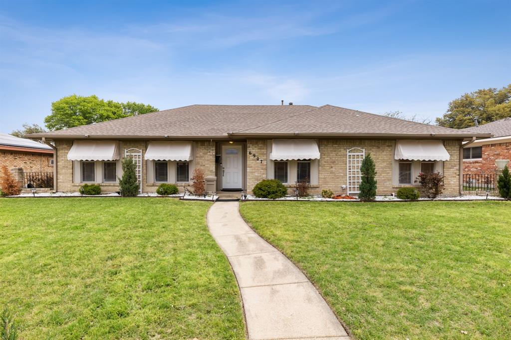 6907 Pickrell Drive Dallas, TX 75227 - Photo 1 of 1 a front view of a house with a yard