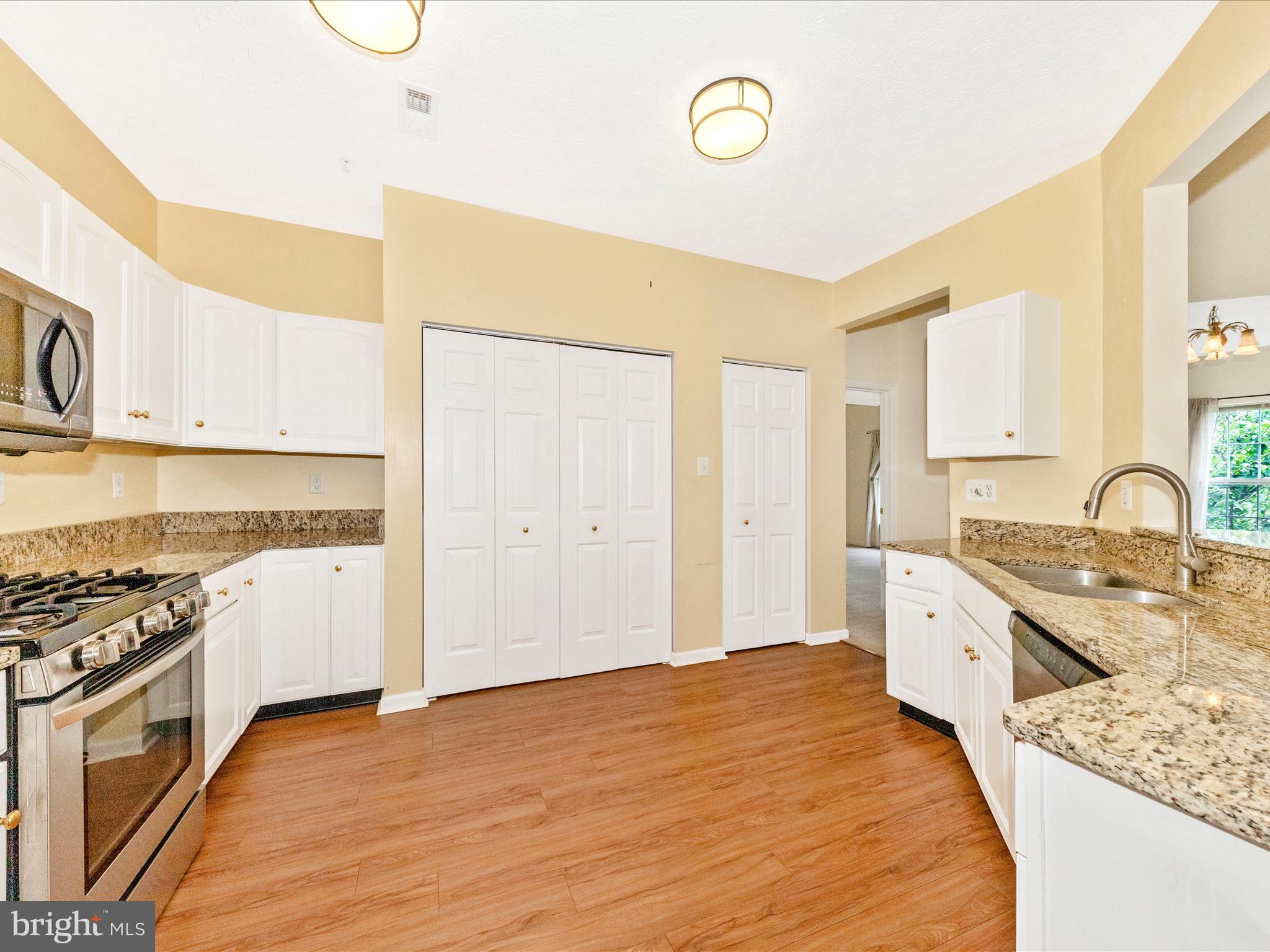 6125 Springwater Place, Unit K Frederick, MD 21701 - Photo 13 of 63 a kitchen with stainless steel appliances granite countertop a stove and a sink