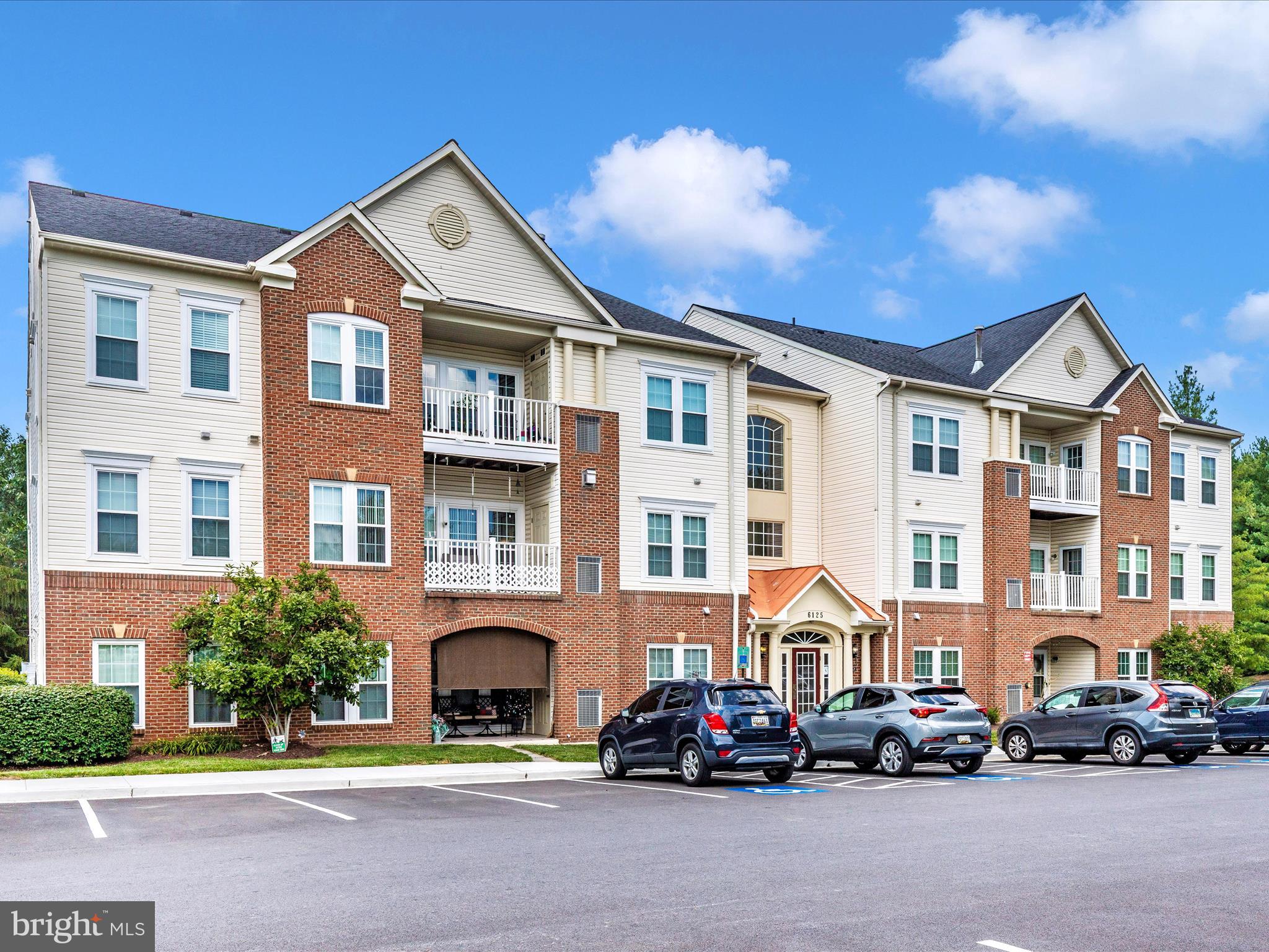 6125 Springwater Place, Unit K Frederick, MD 21701 - Photo 39 of 63 a car parked in front of a brick house
