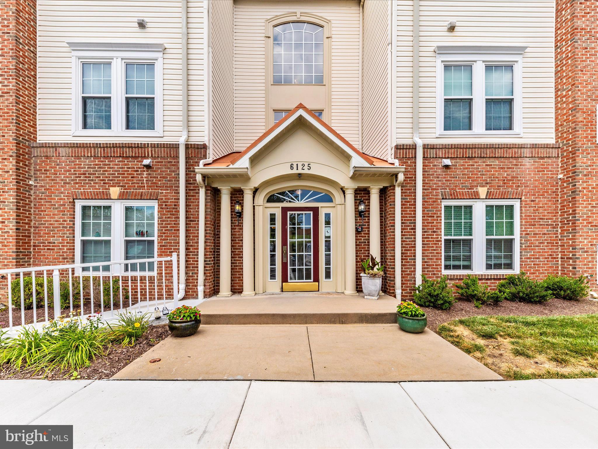 6125 Springwater Place, Unit K Frederick, MD 21701 - Photo 40 of 63 a front view of a house with garden