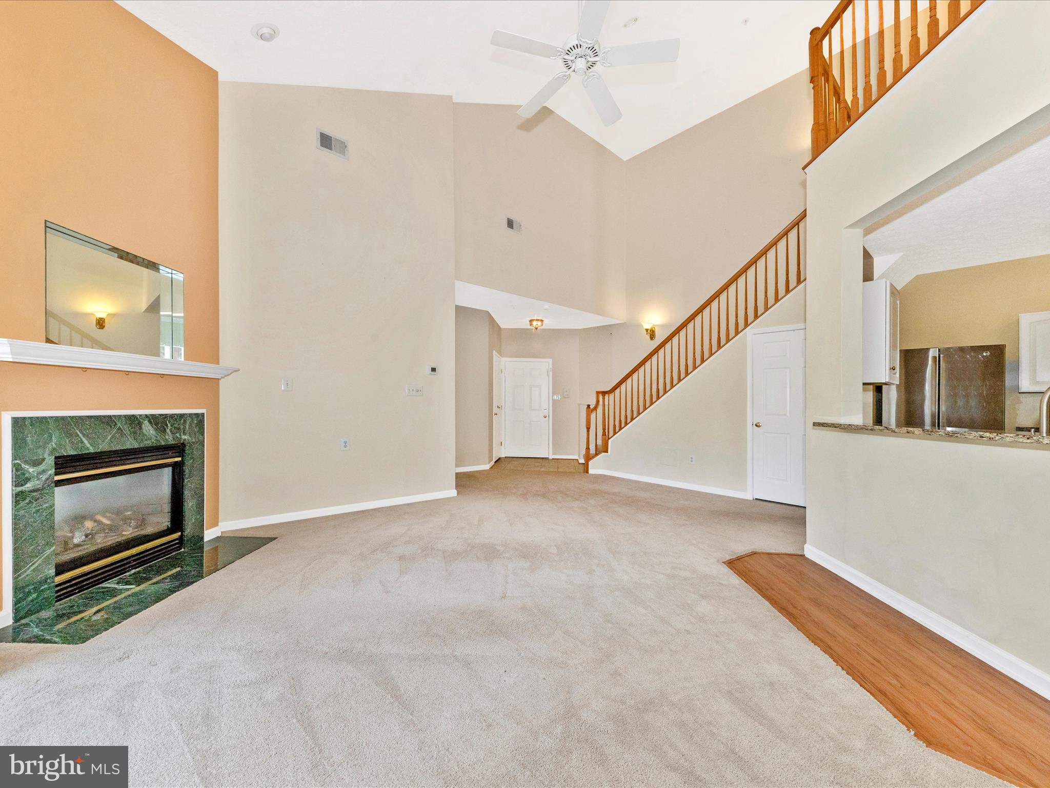 6125 Springwater Place, Unit K Frederick, MD 21701 - Photo 5 of 63 a view of an empty room with wooden floor fireplace and a window