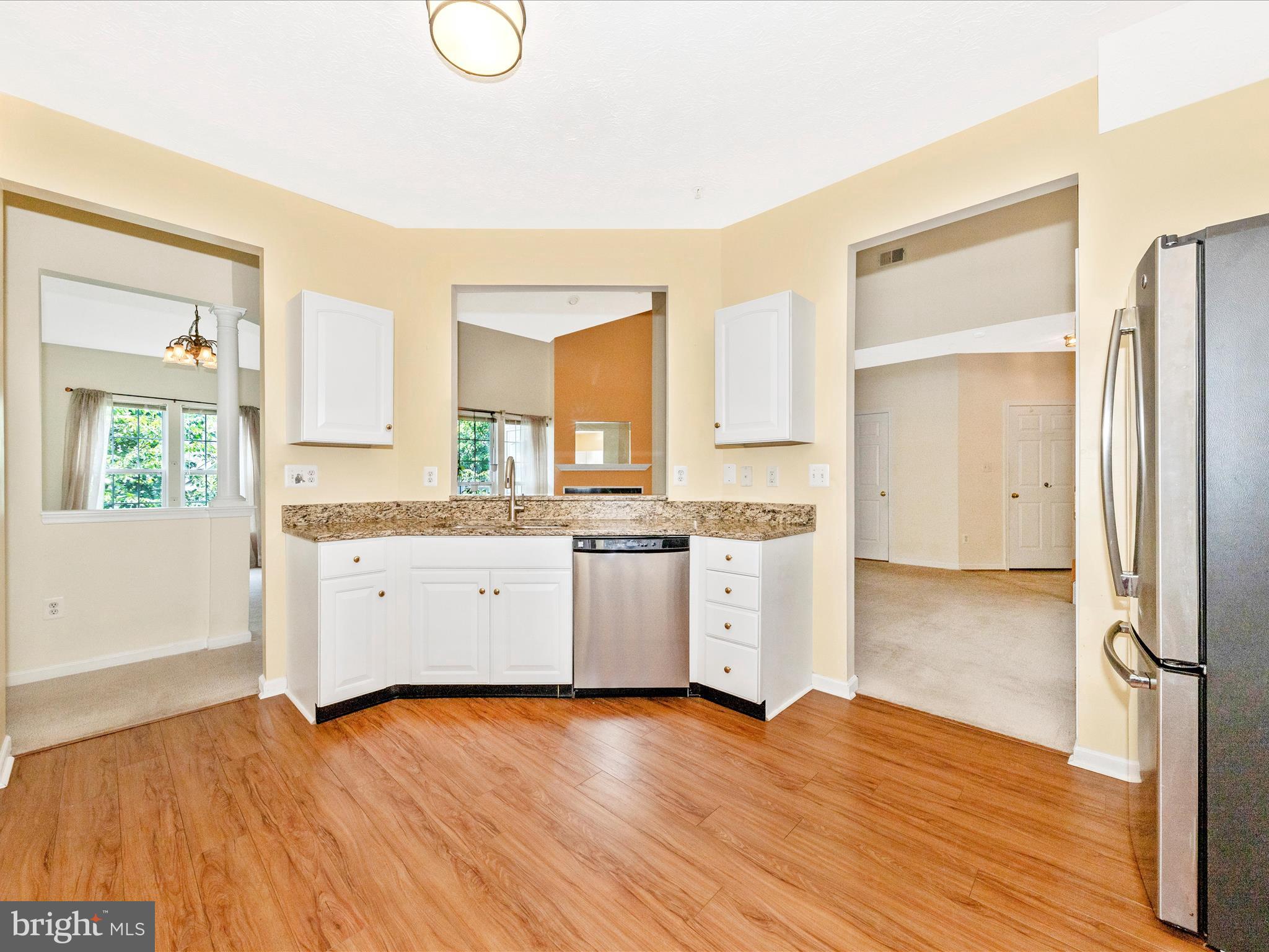 6125 Springwater Place, Unit K Frederick, MD 21701 - Photo 9 of 63 a kitchen with a refrigerator and white cabinets