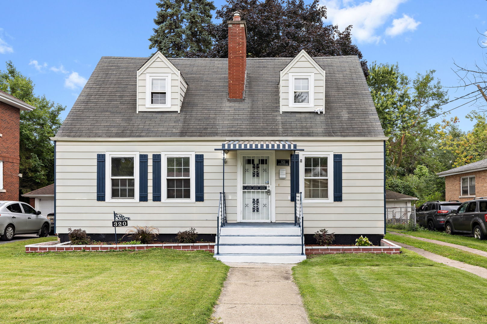 320 Streamside Drive Harvey, IL 60426 - Photo 1 of 26 a front view of a house with a yard