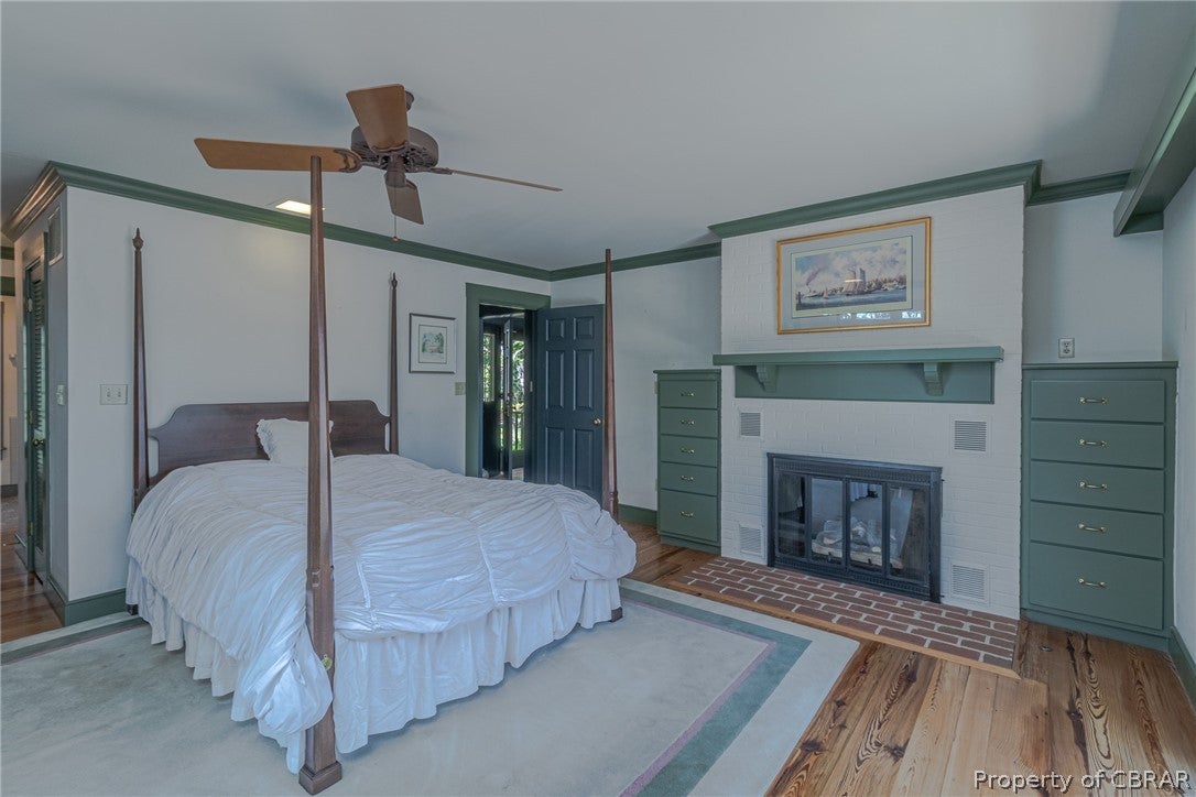 85 Rivers Bend Road Lancaster, VA 22503 - Photo 22 of 46 Bedroom with built-in cabinents and fireplace