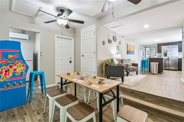 a view of a livingroom with furniture and a dining table with wooden floor