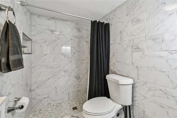 a bedroom with a bed and a lamp