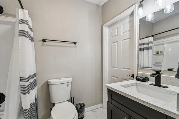 a bathroom with a sink a mirror a bathtub and shower