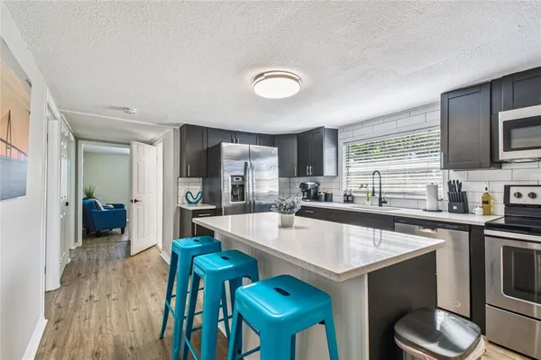 a kitchen with a sink cabinets and wooden floor