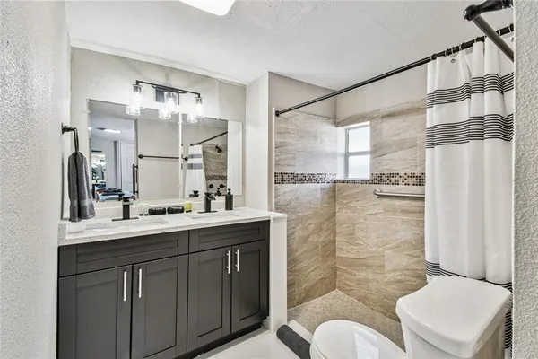 a bathroom with a toilet and a shower