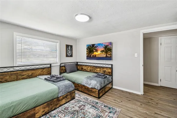 a bedroom with two beds and a window