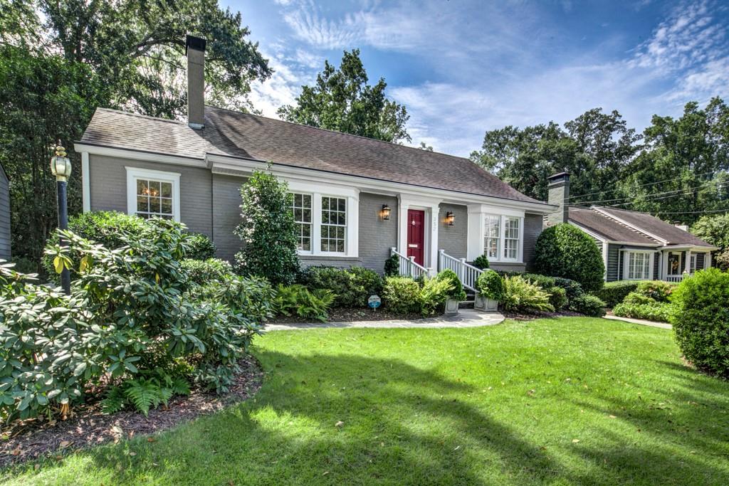 352 Redland Road Northwest Atlanta, GA 30309 - Photo 1 of 1 a front view of a house with a yard and potted plants