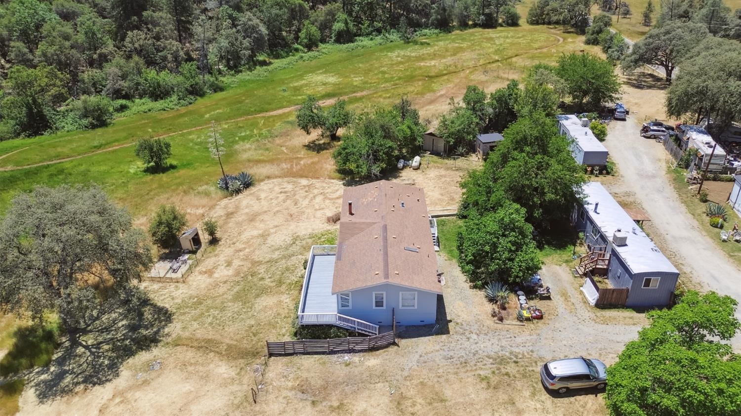an aerial view of a house with a yard and lake view