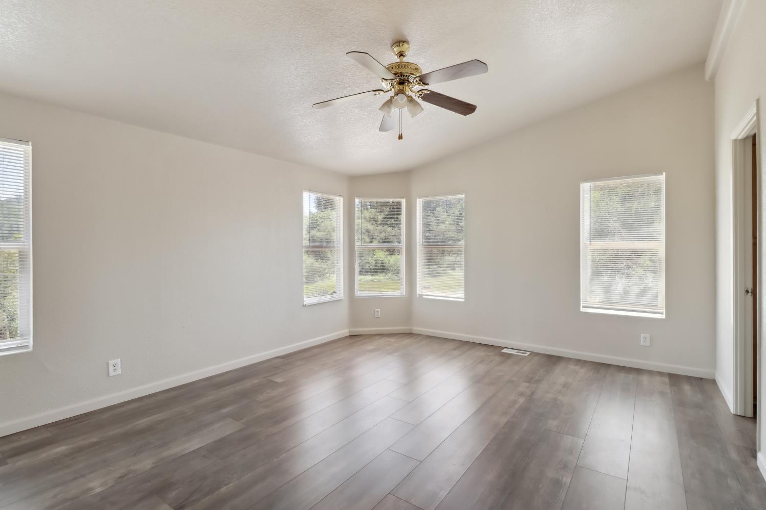 22115 Pleasant Valley Road North San Juan, CA 95960 - Photo 18 of 85 a view of an empty room with wooden floor and a window