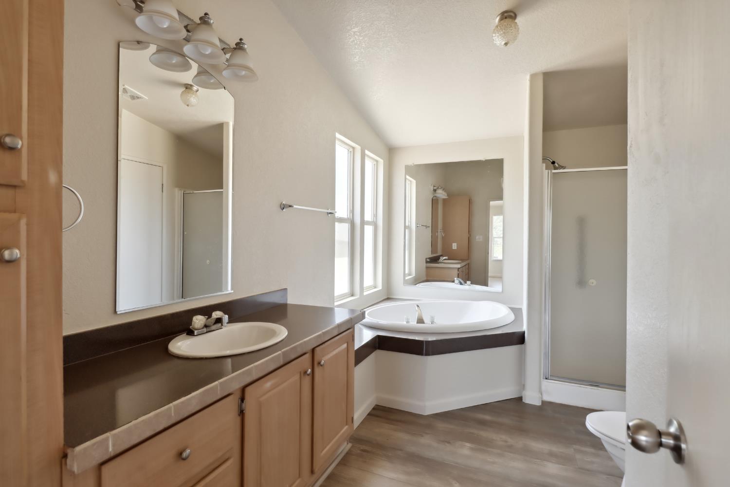 22115 Pleasant Valley Road North San Juan, CA 95960 - Photo 22 of 85 a bathroom with a sink double vanity granite tub shower and a mirror