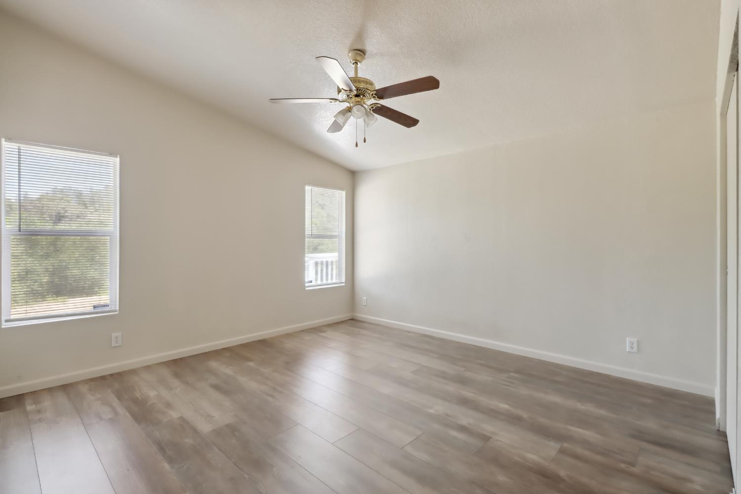 22115 Pleasant Valley Road North San Juan, CA 95960 - Photo 24 of 85 an empty room with wooden floor fan and windows