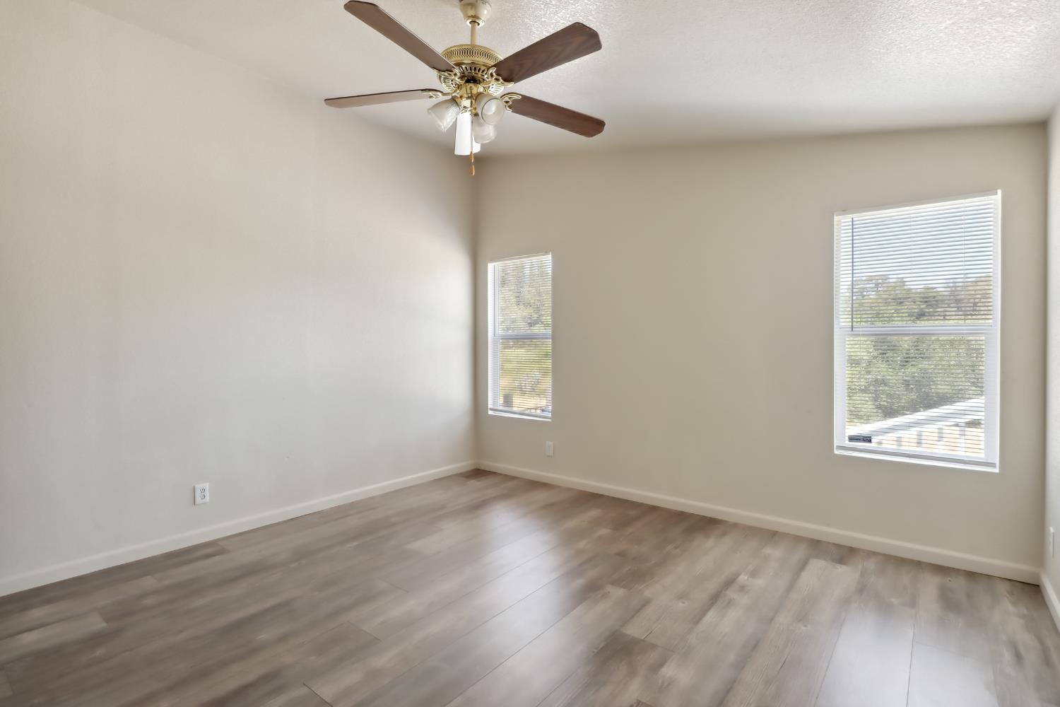 22115 Pleasant Valley Road North San Juan, CA 95960 - Photo 27 of 85 a view of an empty room with a window and wooden floor