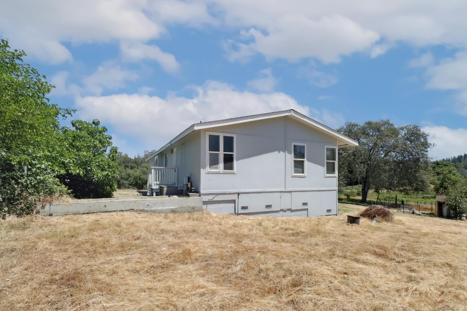 22115 Pleasant Valley Road North San Juan, CA 95960 - Photo 50 of 85 a view of a house with backyard and trees in the background