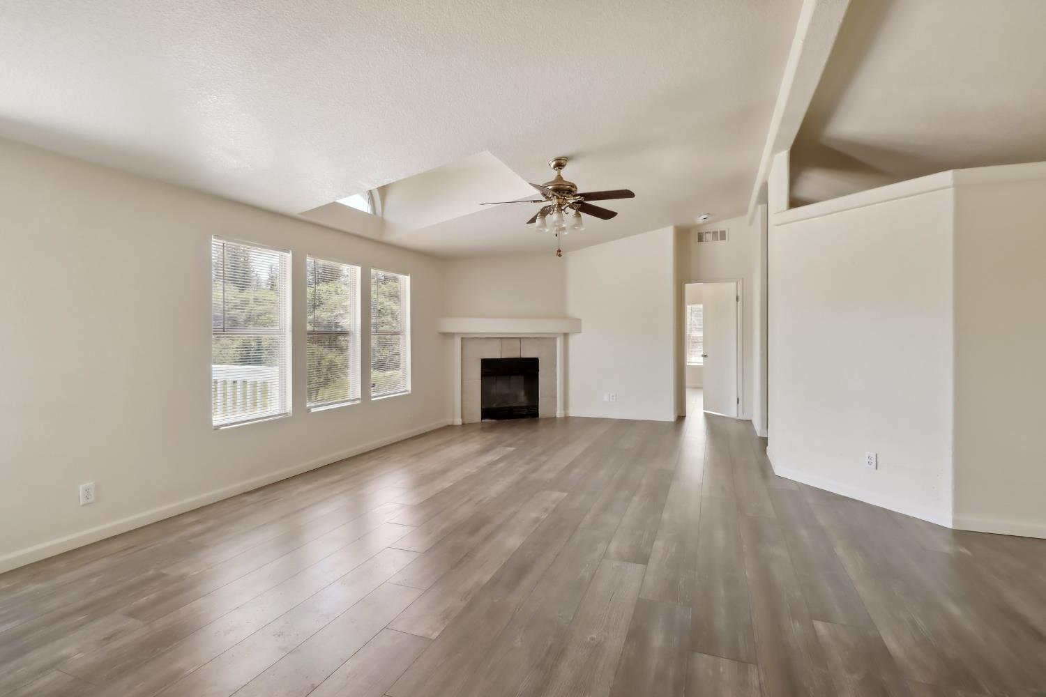 22115 Pleasant Valley Road North San Juan, CA 95960 - Photo 5 of 85 a view of an empty room with a fireplace and a window