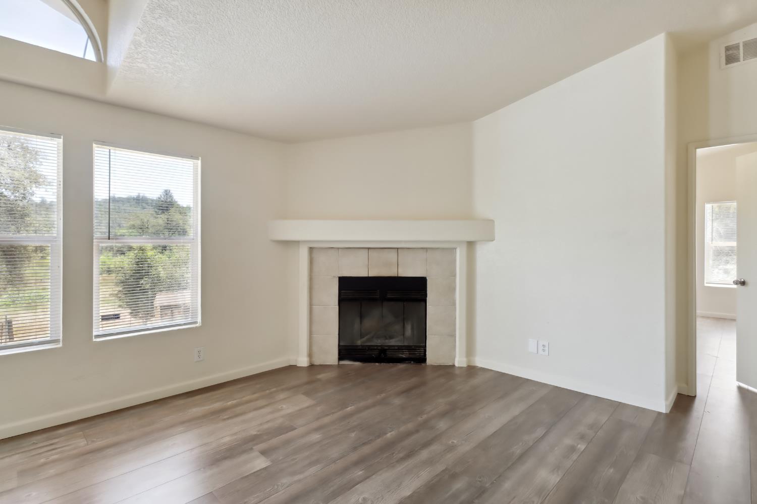 22115 Pleasant Valley Road North San Juan, CA 95960 - Photo 6 of 85 a view of an empty room with a fireplace and a window