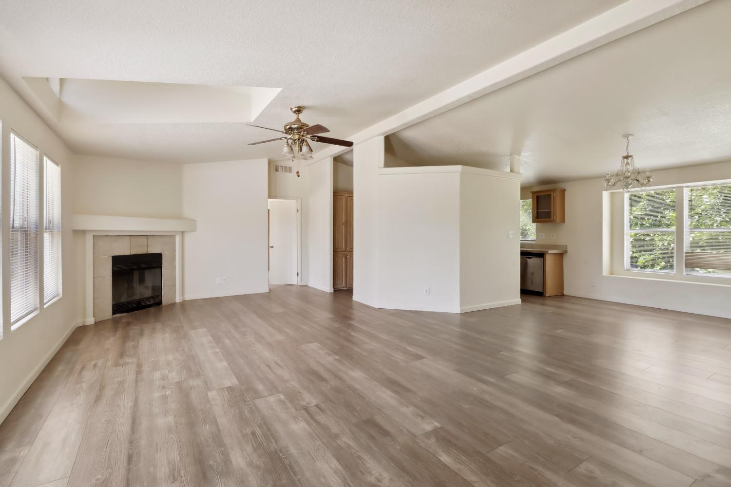 22115 Pleasant Valley Road North San Juan, CA 95960 - Photo 7 of 85 an empty room with wooden floor fireplace and windows