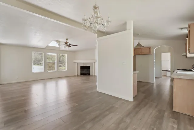 a view of livingroom with hardwood floor and a kitchen