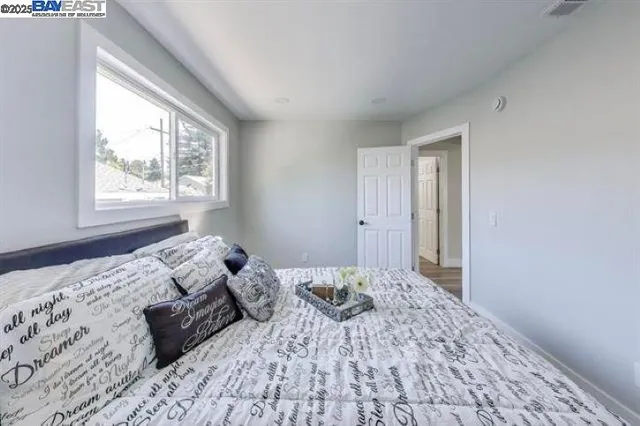 a bedroom with a bed and a window