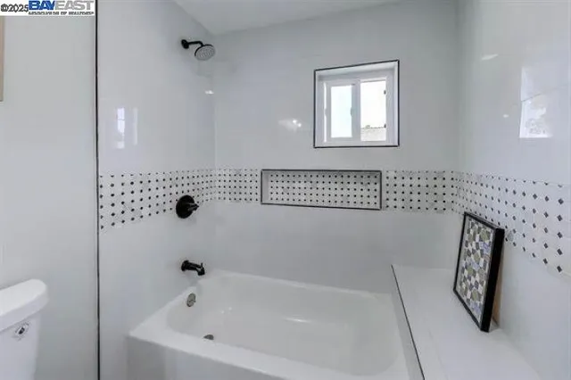 a bathroom with a bathtub and shower