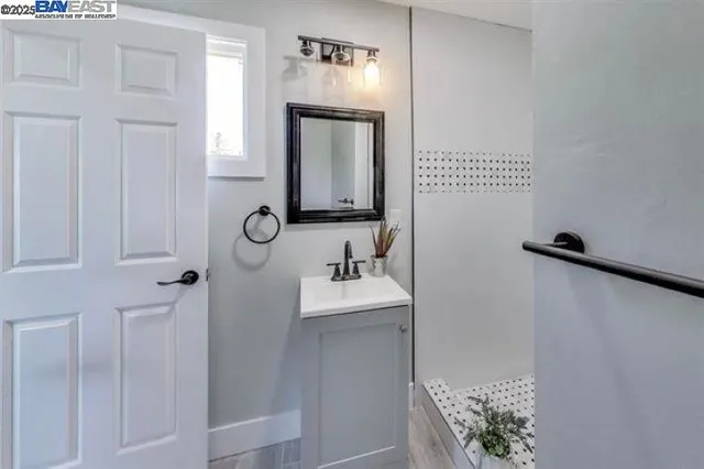 a bathroom with a sink vanity and mirror