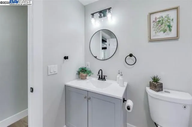 a bathroom with a toilet a sink and a mirror