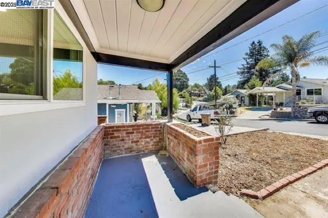a living room with stainless steel appliances granite countertop furniture and a fireplace