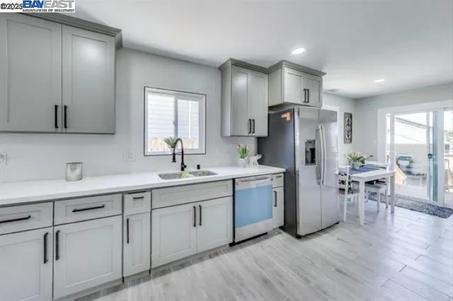 a kitchen with refrigerator and chairs