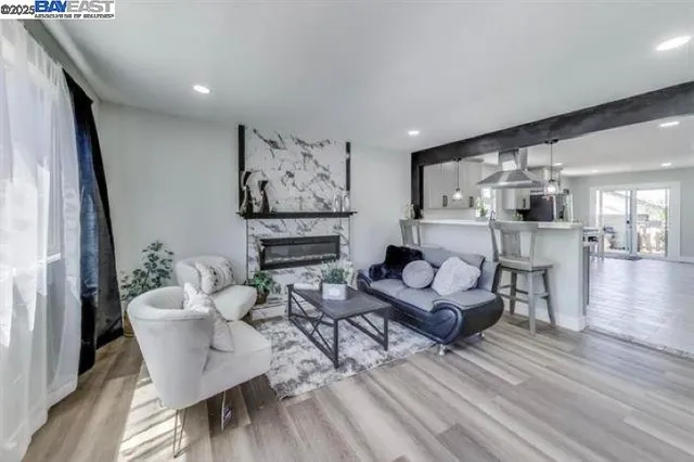 a living room with furniture and wooden floor