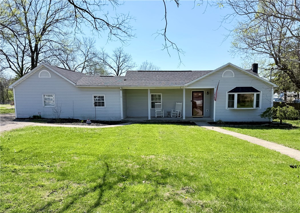 6800 Farmington Road Miamisburg, OH 45342 - Photo 1 of 32 This charming home features a welcoming porch, lush green lawn, and attractive curb appeal.