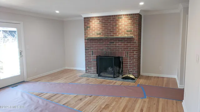 an empty room with a fireplace and window