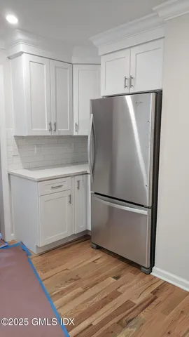 a white refrigerator freezer sitting in a kitchen
