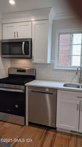 a kitchen with a sink and a microwave