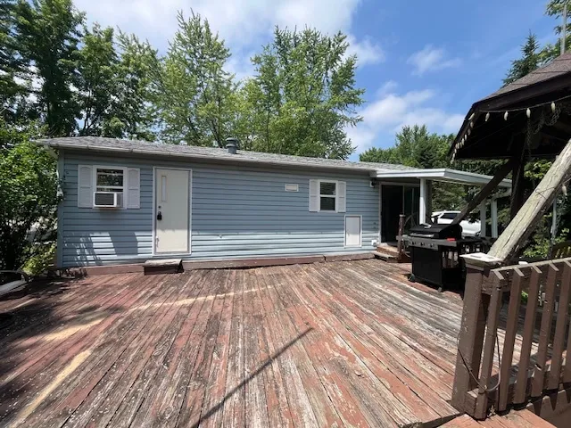 a view of backyard with a barn and a large tree
