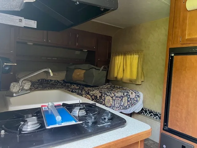 a bed sitting in a bedroom next to a window