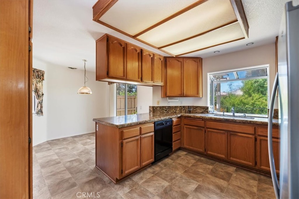 39973 Corte Lorca Murrieta, CA 92562 - Photo 14 of 72 a kitchen with stainless steel appliances granite countertop a sink stove and cabinets