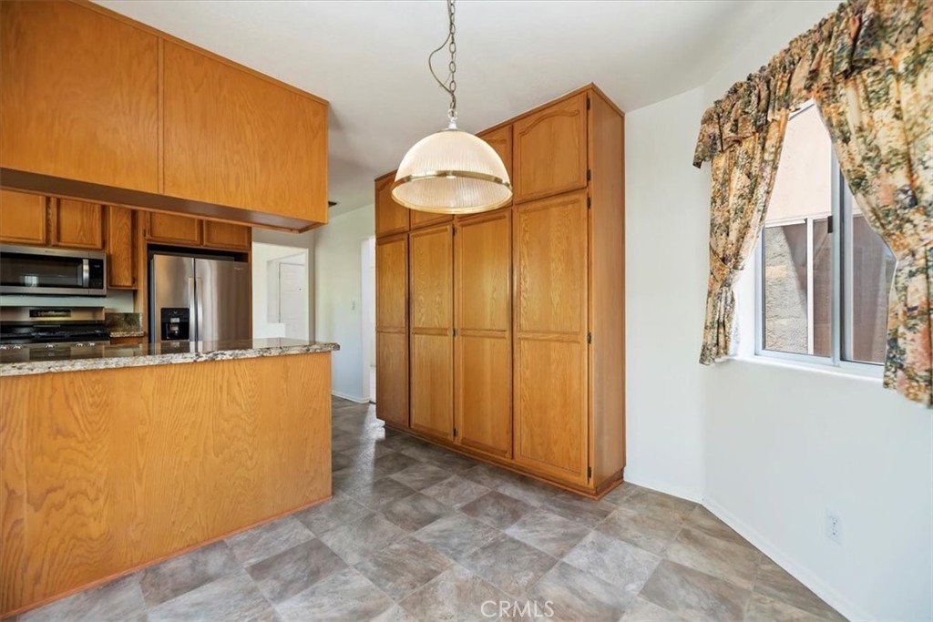39973 Corte Lorca Murrieta, CA 92562 - Photo 17 of 72 a view of a kitchen with a refrigerator and a window